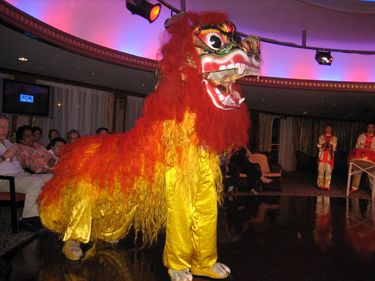 Two men dressed in a Chinese Lion costume.  Lion dance will last approx 7 minute