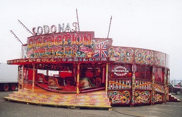 Waltzer cars spin round whilst travelling up and down