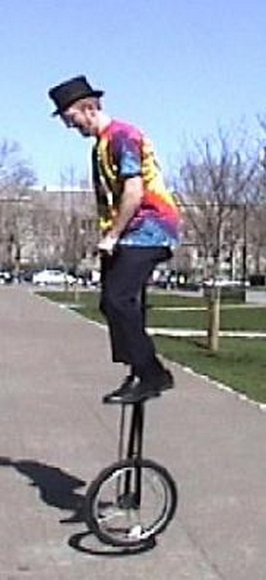 rides his giant unicycle to the amazement of the crowds and then goes further pe