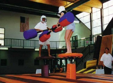 Duel between two gladiators on podiums in the centre of bouncy castle