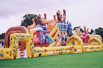 Inflatable obstacle course with bouncy castle, bish bash, cargo netting, slide