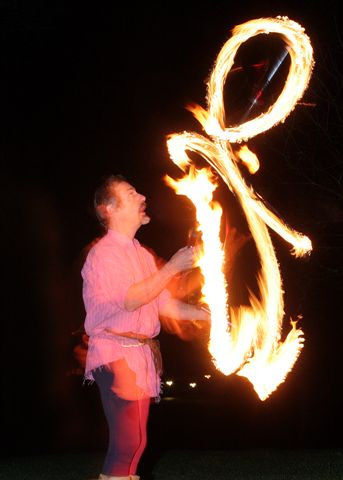 Juggler with fire clubs